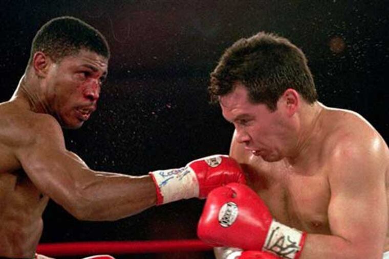 FILE - In this March, 29,1997 file photo, Tony Martin, left, of Philadelphia, punches Mexico's Julio Cesar Chavez in the second round of their Welterweight Special Attraction fight, in Las Vegas. Police say that Martin, a former welterweight, was fatally shot Friday, March 8, 2013. He was 52. (AP Photo/Jeff Scheid, File)