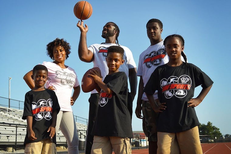 Videographer Mike Starling and his family. Clockwise from upper left: wife Keisha Starling, Starling (with ball), Saafir Starling, 19; Syeer Starling, 12; Shakur Starling, 10; and Shyheim Starling, 8.