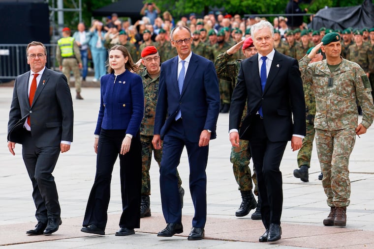 Lithuania's Defense Minister Dovilė Šakalienė walks with, from right, Lithuania's President Gitanas Nauseda, German Chancellor Friedrich Merz, and German Defense Minister Boris Pistorius, during a formal inauguration of a German brigade for NATO's eastern flank in Vilnius, Lithuania, in May.