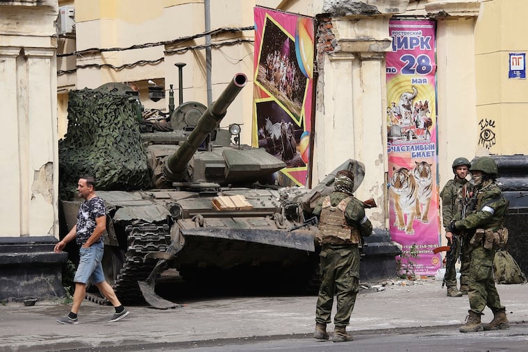 Russian servicemen guard an area standing in front of a tank in a street in Rostov-on-Don, Russia, Saturday, June 24, 2023. Russia's security services have responded to mercenary chief Yevgeny Prigozhin's declaration of an armed rebellion by calling for his arrest. (Vasily Deryugin, Kommersant Publishing House via AP)