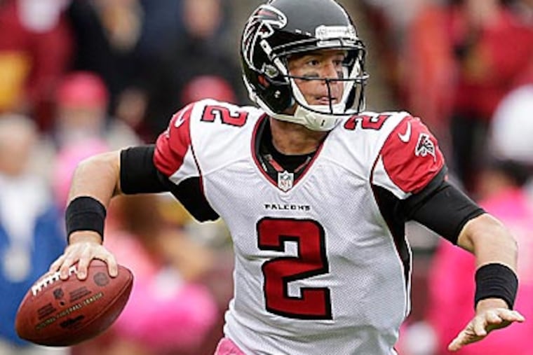 Falcons quarterback Matt Ryan scrambles with the ball during the first half of an NFL football game against the Redskins. (Evan Vucci/AP)