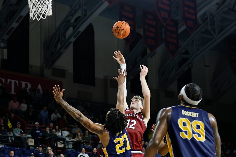 TJ Power (center) led Penn's big second-half comeback, and led all scorers in the game with 29 points.