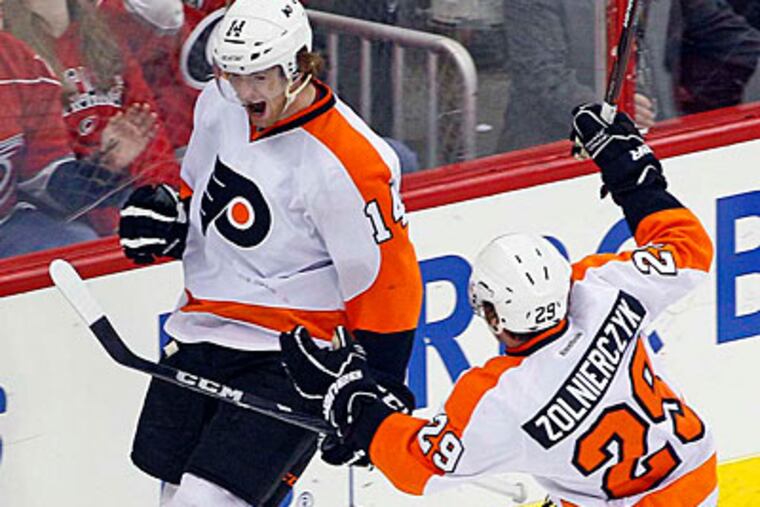 Sean Couturier celebrates his game-winning goal with teammate Harry Zolnierczyk during the third period. (Karl B DeBlaker/AP Photo)