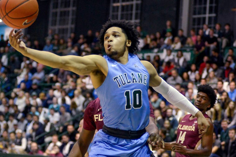 Tulane's guard Caleb Daniels, 10, fights for the ball during the first half of an NCAA Men's college basketball game against Florida State in New Orleans on Sunday, Nov. 11, 2018. (AP Photo/Veronica Dominach)