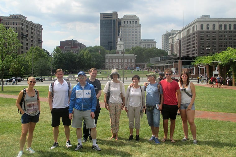 A recent tour group of a guide who does three 90-minute walking tours a day. The tourists are on "the lawn," between Independence Hall and the Constitution Center. They are (from left) a Californian, three Germans, an Australian, and four Spaniards. CLARK DeLEON