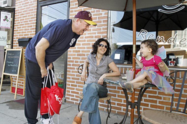 Mayor Ed Forte (left) chats with Andrea Boboc and her daughter Tanya, 2, outside Bobocs Rendezvous coffee shop on Station Avenue. Forte walks for fitness, fun, and work. ELIZABETH ROBERTSON / Staff Photographer