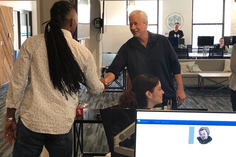 JPMorgan CEO Jamie Dimon, right, meets trainers and students at Zip Code Wilmington, a coding school in Philadelphia, Pa. Dimon chairs the Business Roundtable, which Monday came out, saying CEOs should have broader societal goals in mind, not just their firm's bottom line. (Erin Arvedlund/The Philadelphia Inquirer/TNS)