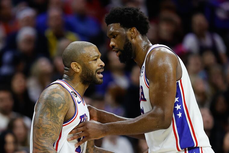 Sixers center Joel Embiid holds back teammate forward P.J. Tucker against the Denver Nuggets on Saturday, January 28, 2023 in Philadelphia.