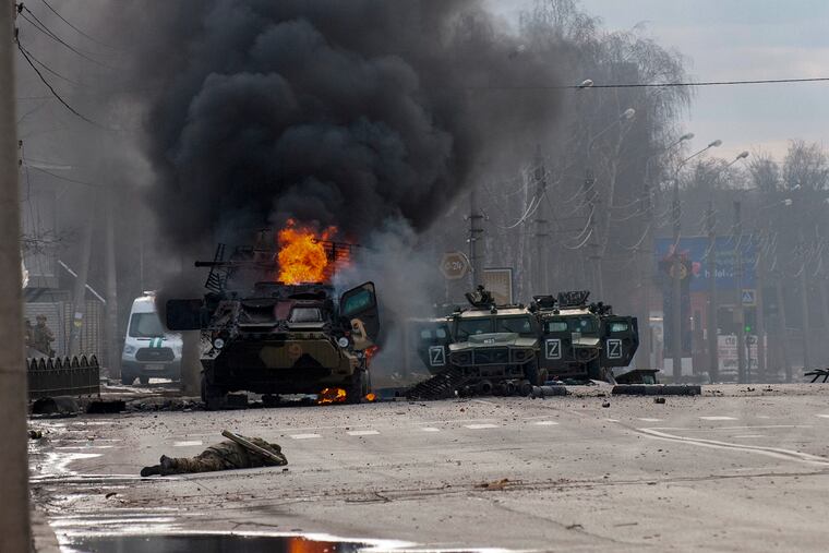 A Russian armored personnel carrier burned amid damaged and abandoned light utility vehicles after fighting in Kharkiv, the second-largest city in Ukraine, on Feb. 27.