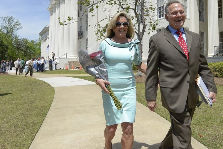Roy Moore and his wife, Kayla, in April 26, 2017, outside the Capitol in Montgomery, Ala.