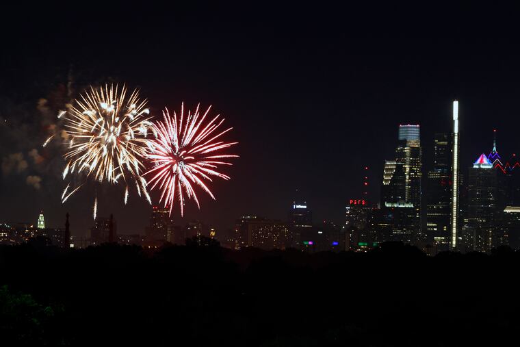 Fireworks at the Art Museum and across the city seen from the Mann Center for the Performing Arts on Sunday.