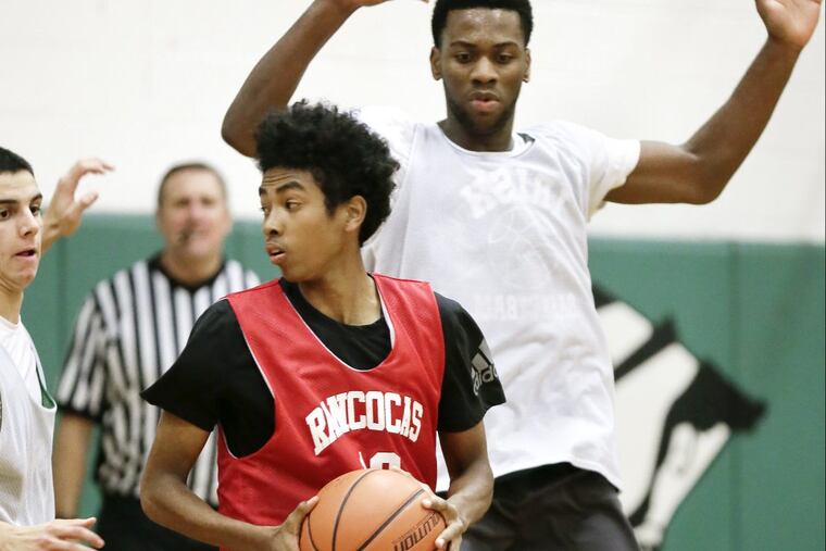 Rancocas Valley’s Damilola Mosaku-an tries to turn around the defense of Camden Catholic’s Uche Okafor during the Rancocas Valley at Camden Catholic HS boys basketball scrimmage on December 13, 2017.