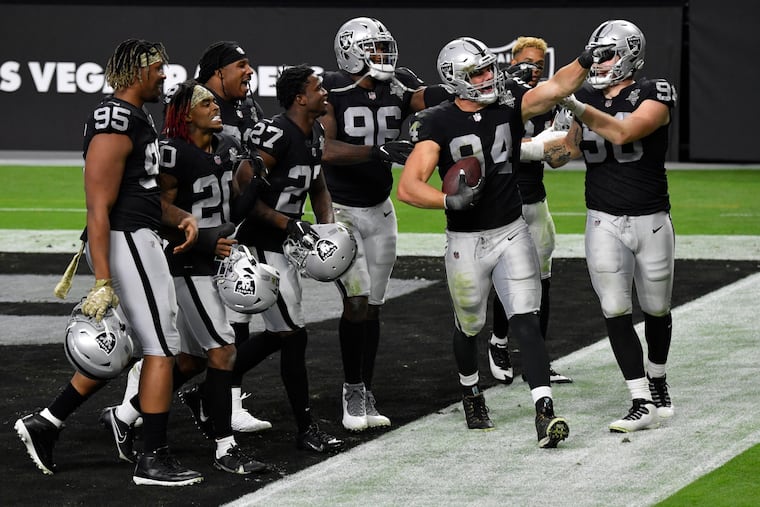 Carl Nassib (94) celebrates with Raiders teammates after grabbing an interception during the Raiders' game against the Denver Broncos last November in Las Vegas.