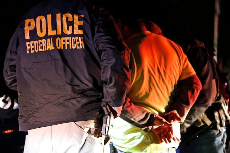 U.S. Immigration and Customs Enforcement agents surround and detain a person during a 2018 raid in Richmond, Va. ICE's enforcement and removal operations, like the five-person field office team outside Richmond, hunt people in the U.S. illegally, some of whom have been here for decades, working and raising families.