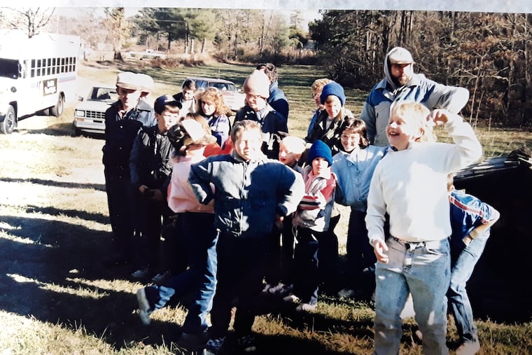 Wilderness Scouts of Blairsville, Georgia wait with their leader, Harold Cornwell, to board a bus sent by Donald Trump for their Christmas activities in 1988.