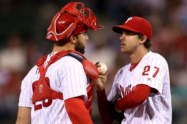 Phils catcher Cameron Rupp visiting with Aaron Nola in the fourth. "He relies on command, and if he doesn't have his command, he's vulnerable," manager Pete Mackanin said of Nola. Associated Press