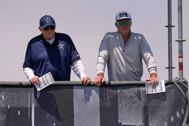 Cowboys owner, president and general manager Jerry Jones, left, stands with his son Stephen Jones during training camp on July 22 in Oxnard, Calif.
