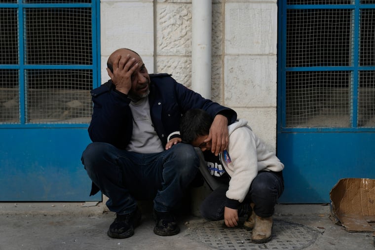 Mourners wait outside the morgue for the funeral of six Palestinians who were killed during an Israeli airstrike on Wednesday, in the West Bank refugee camp of Jenin.