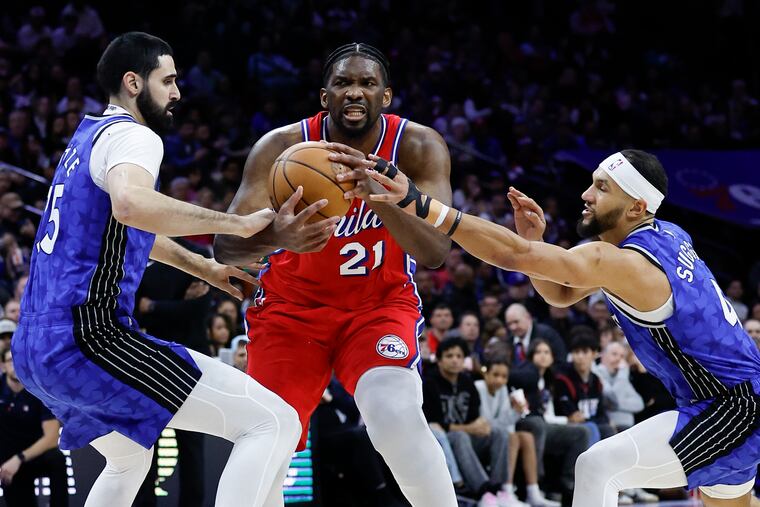 Sixers center Joel Embiid scored a game-high 32 points despite leaving late in the first half after he appeared to hurt his left knee.