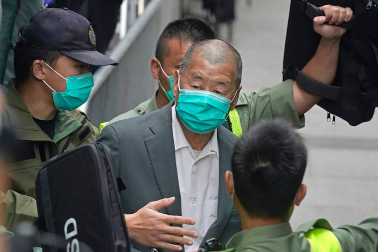Democracy advocate Jimmy Lai leaves court in 2021. He has been sentenced to 20 years in prison in Hong Kong.