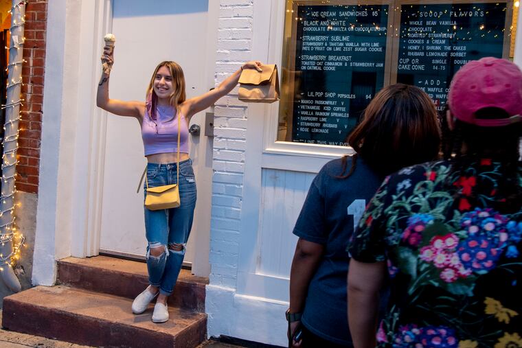 Courtney Arce poses for Craig Rounsaville as he takes a photo of her and her cone at WeckerlyÕs Ice Cream in Fishtown, as a happy mood emerges for people in the region.