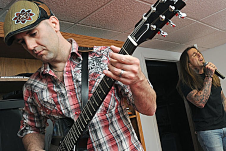 AmBlur guitarist Rich Palumbo and his brother, vocalist Lou Palumbo, practice for the Rockin' Docs show. APRIL SAUL / Staff Photographer