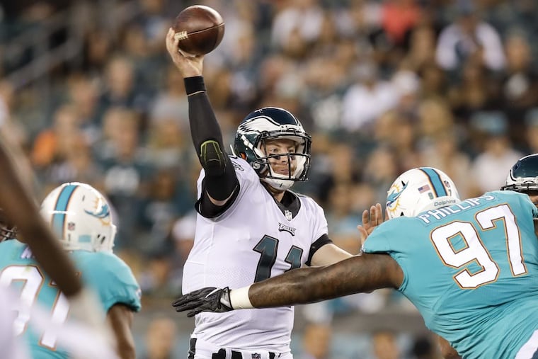Eagles quarterback Carson Wentz throws the football against Dolphins defensive tackle Jordan Phillips during the first quarter in a preseason game on Thursday.