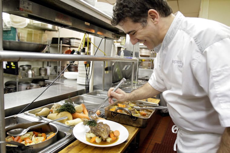 Chef/owner Patrice Rames plates braised lamb shank at Bistro St. Tropez.