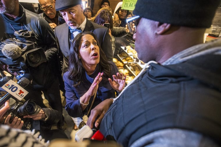 Camille Hymes, center, regional vice president of MidAtlanitc Operations at Starbucks Coffee Company, speaks with Asa Khalif, of Black Lives Matter Pennsylvania.