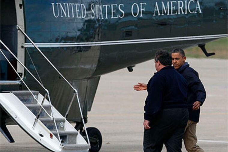 President Obama escorts N.J. Gov. Christie to the helicopter Marine One, at Atlantic City International Airport, before the two toured storm-damaged towns. (David Maialetti / Staff Photographer)