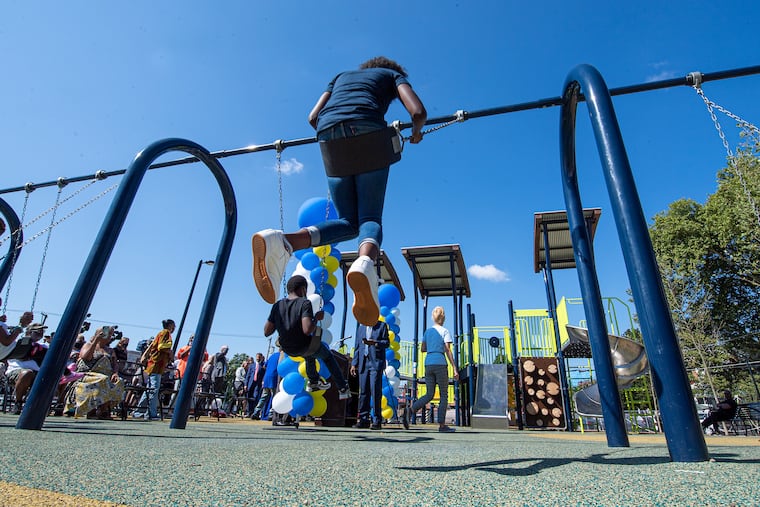Kids play in the new Williams Moore Reed Memorial Park in North Philadelphia, named in honor of Keisha Williams and her three children, who were struck and killed by a carjacked vehicle in 2014 while running a fruit stand to raise money for a new playground at their church.