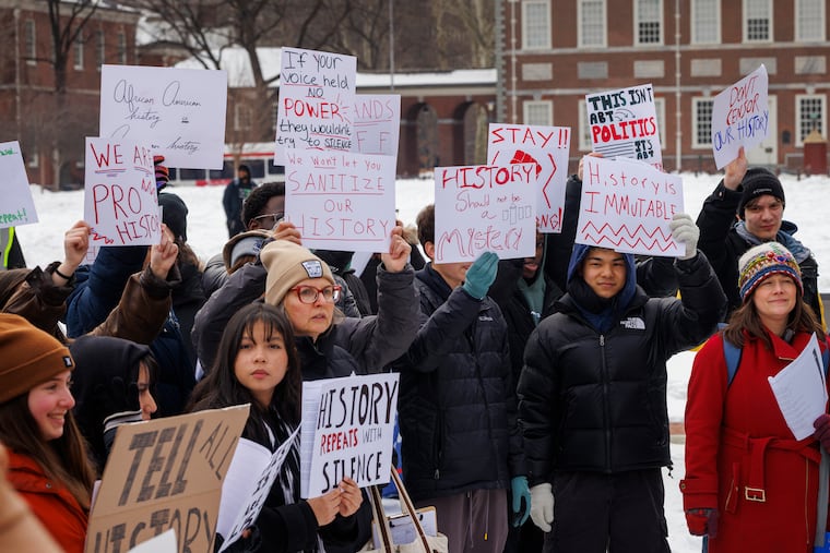 Young people hold up signs during history lesson and protest at the President's House Site, Independence National Historical Park, Philadelphia, Friday, Feb. 6, 2026. They are protesting the removal of the slavery exhibit at this site.
