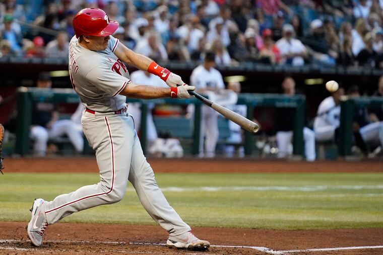 Philadelphia Phillies' J.T. Realmuto connects for a two-run triple against the Arizona Diamondbacks during the third inning of a baseball game Monday, June 12, 2023, in Phoenix.