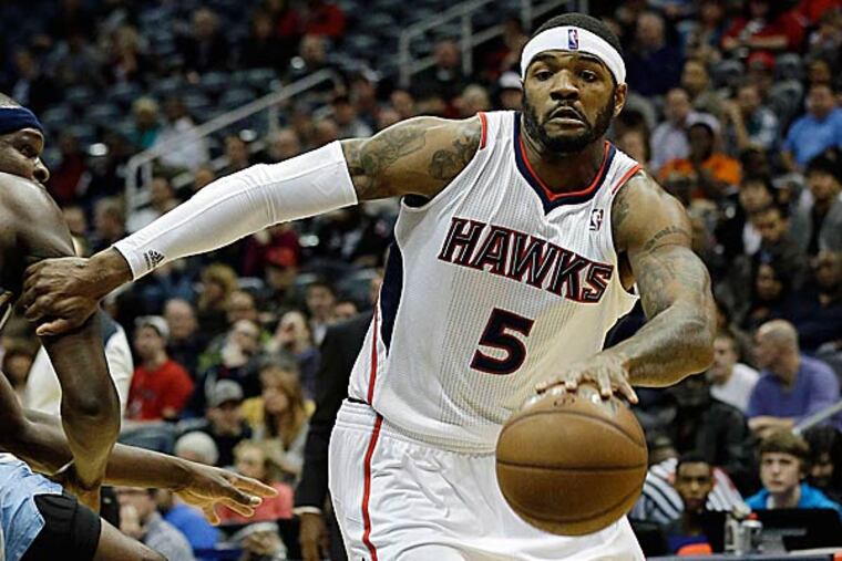 The rumors of trades start to fly this time of season, and the one involving the Sixers centers around Atlanta's Josh Smith being acquired for Evan Turner and Spencer Hawes. (John Bazemore/AP)