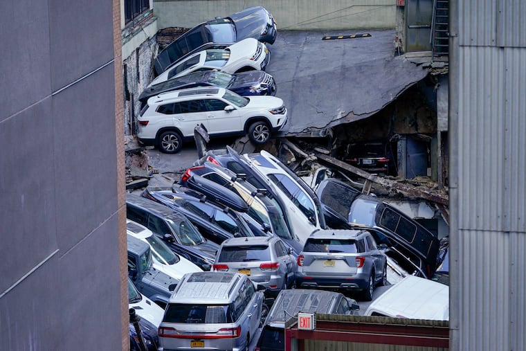 Cars are seen piled on top of each other at the scene of a partial collapse of a parking garage in the Financial District of New York on Tuesday.