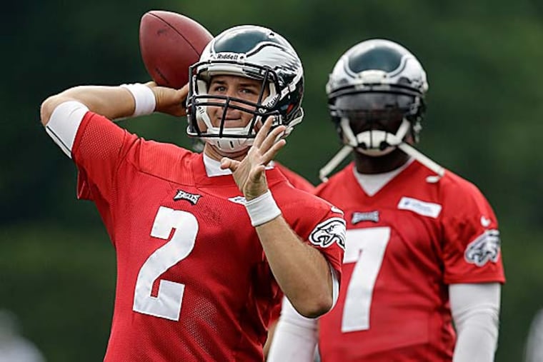 The Eagles have a good, old fashioned quarterback competition that will play out through the hot days of training camp. (Matt Rourke/AP)