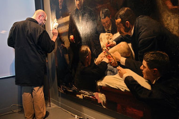 Allen Kosanovich, a Mellon Fellow in Conservation, works on restoring the part of the "Gross Clinic" painting where the gallery is watching the surgery. (Michael Bryant / Staff Photographer)