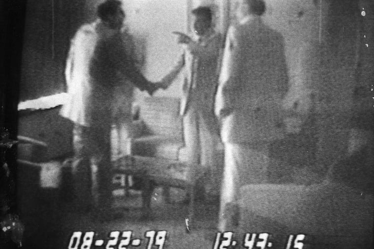 In an Abscam videotape segment broadcast by NBC, undercover agent Anthony Amoroso shakes hands with Camden Mayor Angelo Errichetti in 1979 after money placed in an envelope by Amoroso was handed to Michael J. (Ozzie) Myers (who is not visable and in front of Amoroso). FBI informant Mel Weinberg looks on standing at right at a hotel near John F. Kennedy International Airport in New York. This photo was taken from an NBC Monitor.
Photo by Michael Viola 10/14/80
KYW-TV/Abscam tapes/News