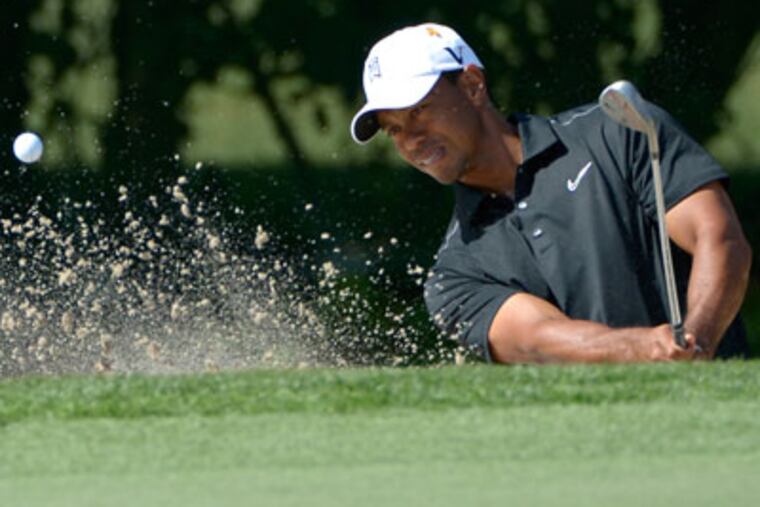 Tiger Woods hits out of a bunker during the first round of the Arnold Palmer Invitational. (Phelan M. Ebenhack/AP)
