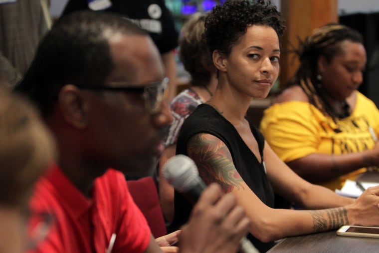 Brianna Jones listens as Asa Khalif, one of the founders of the Philadelphia Coalition for REAL Justice, speaks as local protest leaders hold a meeting to finalize plans for the Democratic National Convention.