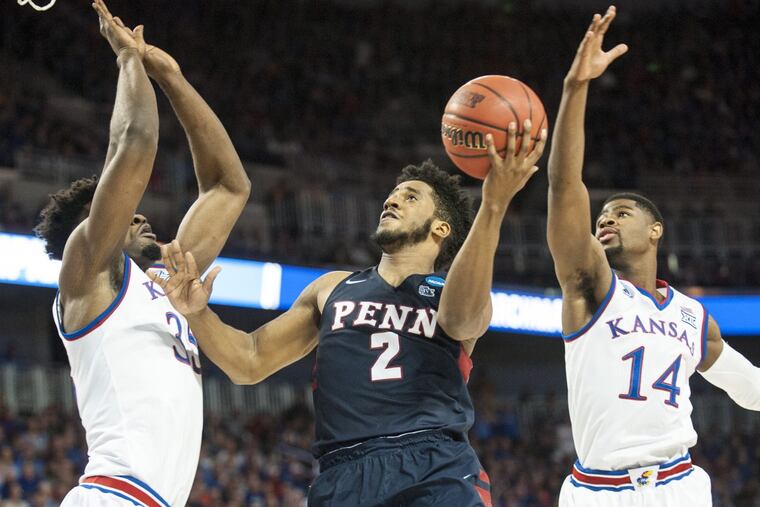 Penn guard Antonio Woods looks to shoot between Kansas defenders Udoka Azubuike (35) and Malik Newman (14) in the first half.