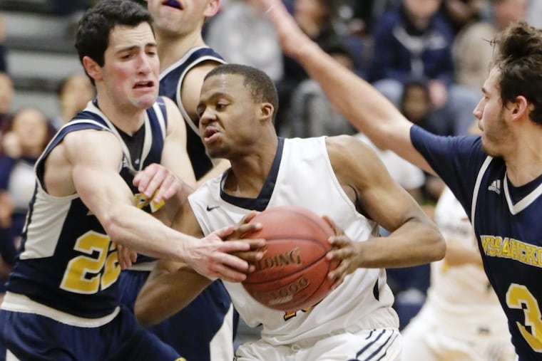 Cheltenham’s Domanik Pope (center) is fouled by Wissahickon’s Max Rapoport (left). Rapoport ended with a game-high 22 points.
