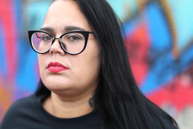 Carmen Pagan of N Plethora Street, .Philadelphia, holds a photo of her son Friday October 13, 2017. DAVID SWANSON / Staff Photographer