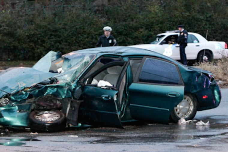 Three undercover officers were riding in this unmarked car when it was broadsided on Windrim Avenue at Wyoming Avenue and it then struck a utility pole. The officer in the passenger seat was the most seriously injured. (Steven M. Falk / Staff Photographer)