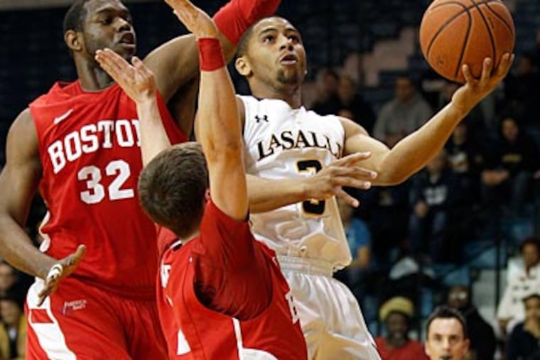 La Salle's Tyreek Duren goes for a layup against Boston University's Jeff Pelage and Matt Griffin. (Yong Kim/Staff Photographer)