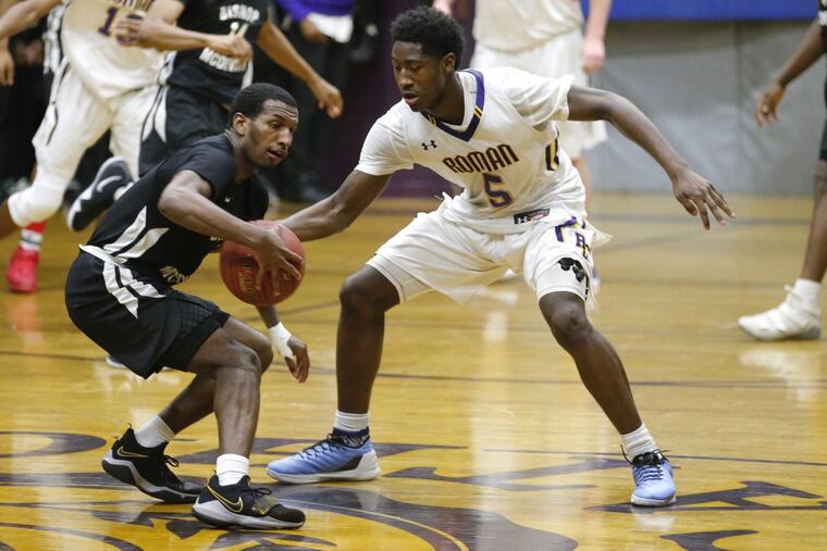 Nate Nicholsen, right, of Roman, gtries to steal the ball from Ahmir Harris of Bishop McDevitt in the 2nd half on Jan 24, 2018.