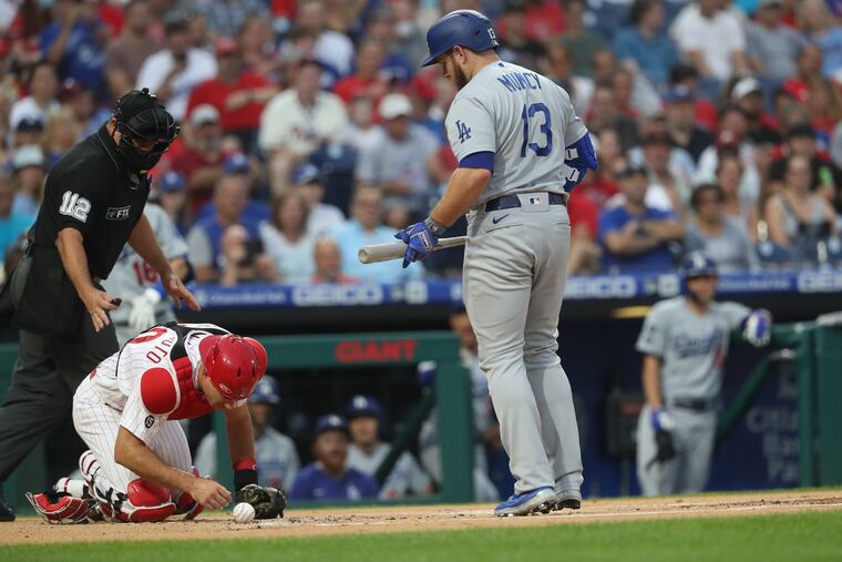 Phillies catcher J.T. Realmuto was hit by a foul ball by Max Muncy of the Dodgers in the first inning Wednesday night. He later left the game.
