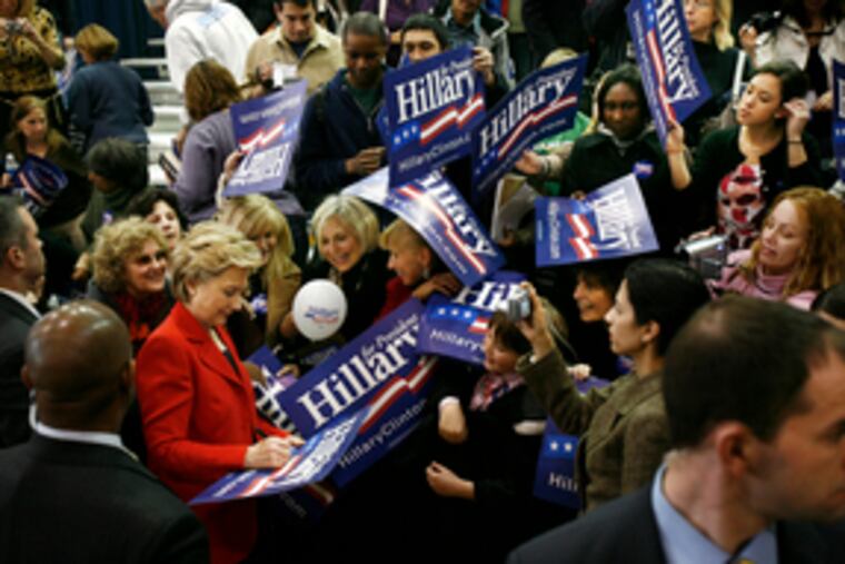 Surrounded by supporters, Sen. Hillary Rodham Clinton signs autographs at Montgomery County Community College. At the rally, she evoked themes of sisterhood and motherhood.