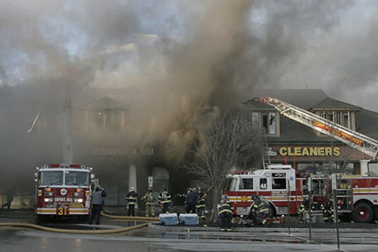 The fire being battled on Evesham Road at a strip mall in front of the Short Hills development.