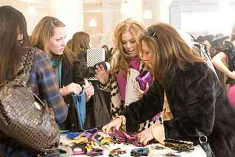 In this image released by Disney, Isla Fisher, second right, is shown in a scene from, Touchstone Pictures' "Confessions of a Shopaholic." (AP Photo/Disney, Robert Zuckerman)